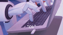 a robotic hand is typing on a laptop with the words " ok " on the bottom