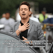 a man in a suit holds his hands to his chest in front of a car with a caption that says using saasant