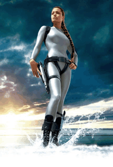 a woman in a wet suit holding a gun