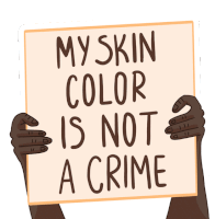 a person holding a sign that says my skin color is not a crime