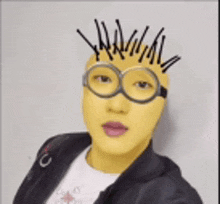 a person with a yellow mask and glasses on their face