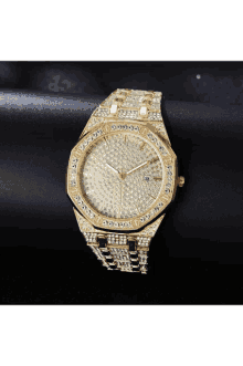 a gold watch with diamonds on the face and a black background