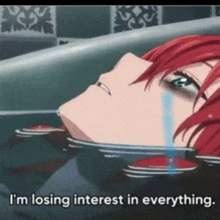 a girl with red hair is crying in a bathtub with the words i 'm losing interest in everything