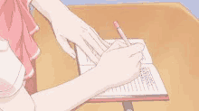 a girl is writing in a notebook with a pencil .