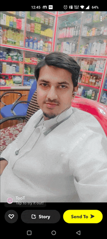 a man in a white shirt is sitting in front of a store shelf