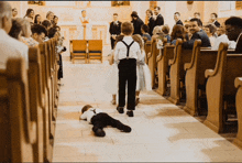 a boy laying on the floor at a wedding