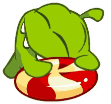 a green cartoon character is laying on a red and white candy cane