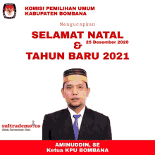 a man in a suit and tie is standing in front of a sign that says selamat natal & tahun baru 2021