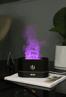 a black box with purple smoke coming out of it sits on a book called central