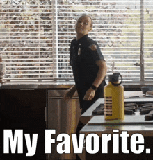 a woman in a police uniform is standing in a kitchen next to a yellow water bottle that says my favorite on it