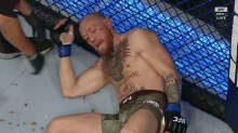 a man in a cage with a tattoo on his chest that says mcgregor