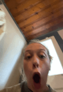 a woman is making a surprised face with her mouth open