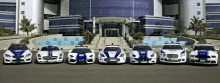 a row of police cars lined up in front of a building