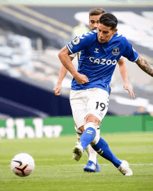 a soccer player in a blue and white jersey with the number 19 on it