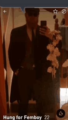 a man in a suit is taking a selfie in front of a mirror with the words hung for femboy 22 at the bottom