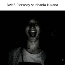 a black and white photo of a person with their mouth open in the dark