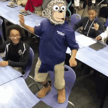 a man wearing a monkey mask is dancing in front of a group of children