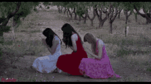 three women in dresses are praying in a field with a watermark that says ' miracle day ' on it