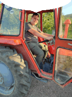 a man is sitting in a red tractor with a srb sticker on it