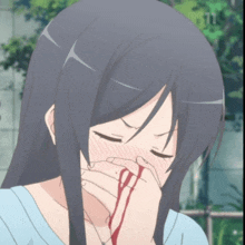 a girl with blood coming out of her nose is covering her mouth with her hand