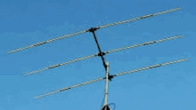 a large antenna is sitting in the middle of a clear blue sky .