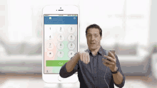 a man is holding a cell phone in front of a phone with a call button on the screen .