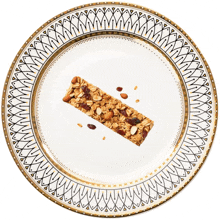 a plate with a granola bar on it and a gold border