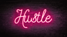 a pink neon sign that says hustle on a brick wall