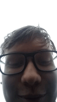 a close up of a person 's face with glasses