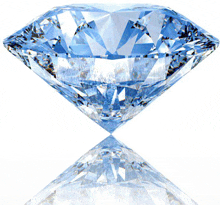 a blue diamond is sitting on a white surface with a reflection