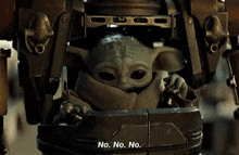 a baby yoda is sitting in a robot and says no . no . no .