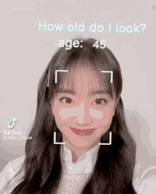 a woman 's face is being scanned by a tiktok app and says how old do i look age 45