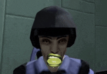 a soldier with a lime in his mouth is wearing a helmet