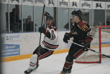 a hockey player with the number 24 on his jersey stands on the ice