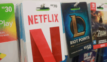 a netflix gift card hangs on a shelf with other gift cards