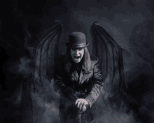 a man with wings and a top hat stands in a dark room