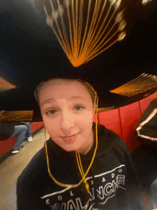 a young boy wearing a sombrero and a shirt that says ' avalanche '