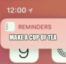 a phone screen shows a reminder that says make a cup of tea