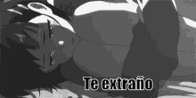 a black and white drawing of a girl laying on a bed with the words `` te extraño '' written above her .