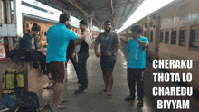 a group of men standing on a train platform with the words cheraku thota lo charedo biyyam written on the top