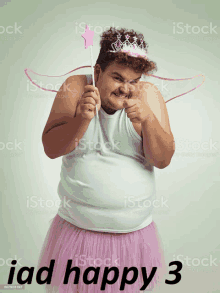 a man dressed as a fairy holding a wand with the words iad happy 3 below