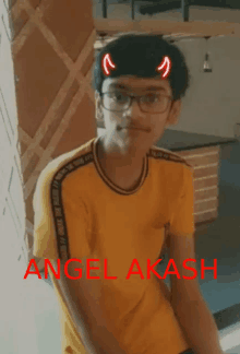 a young boy wearing glasses and a yellow shirt with the name angel akash written on it