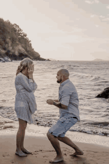 a man proposes to a woman on the beach