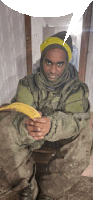 a man in a military uniform is holding a banana in his hand