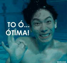 a picture of a man underwater with the words to o otima in white letters