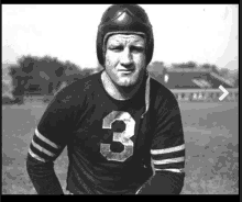 a black and white photo of a football player wearing a number 3 jersey