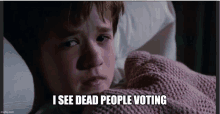 a young boy laying in bed with the words i see dead people voting written below him