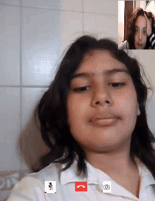 a girl is talking to another girl on a video call with a microphone on the screen