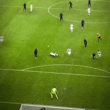 a group of soccer players are playing on a field and one of them is wearing a white jersey with the number 10