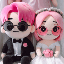 a stuffed bride and groom with pink hair